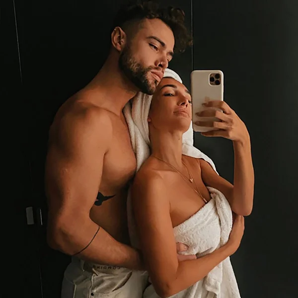 male sugar baby with cougar woman taking selfie
